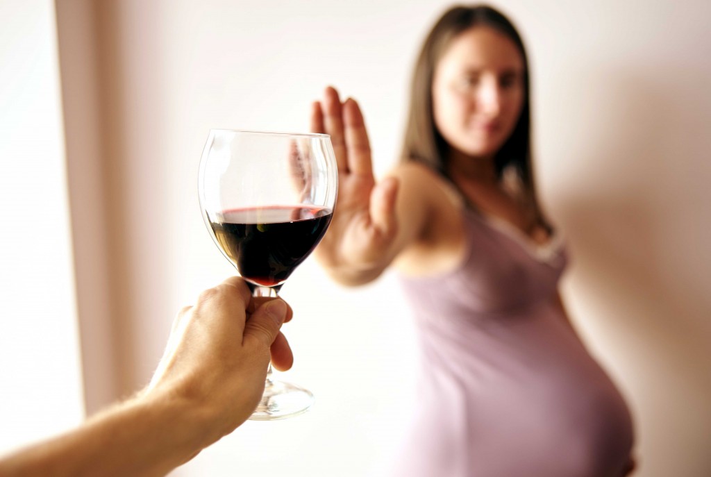 Pregnant Woman Declining Glass Of Wine
