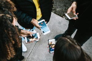 Group of Young Adults Looking at Phone