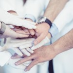 Medical Team Stacking Hands in Circle For Success