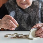 elderly woman counts coins
