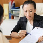 Social Worker At Desk With Client