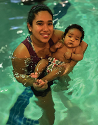 woman holids baby in a swimming pool