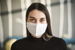 Beautiful girl with medical mask to protect her from virus.