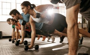 Shot of a group of people doing push-ups with