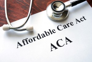 Words Affordable Care Act  ACA written on a paper.