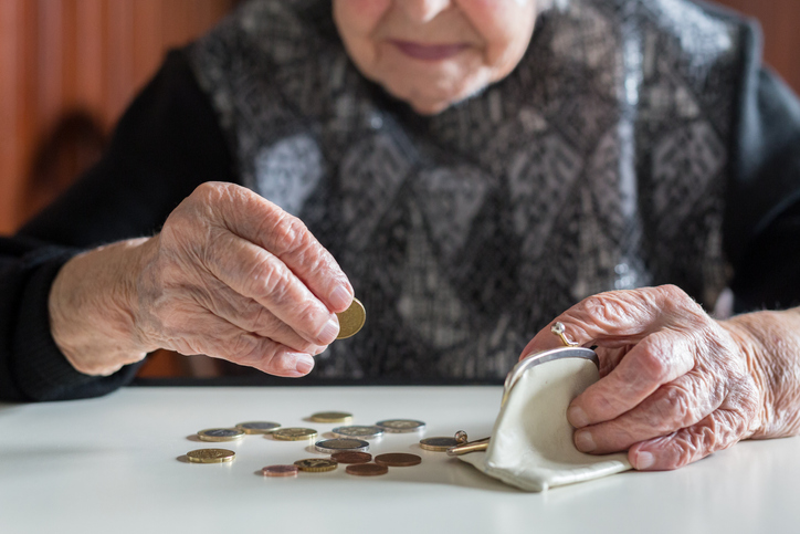 elderly woman counts coins