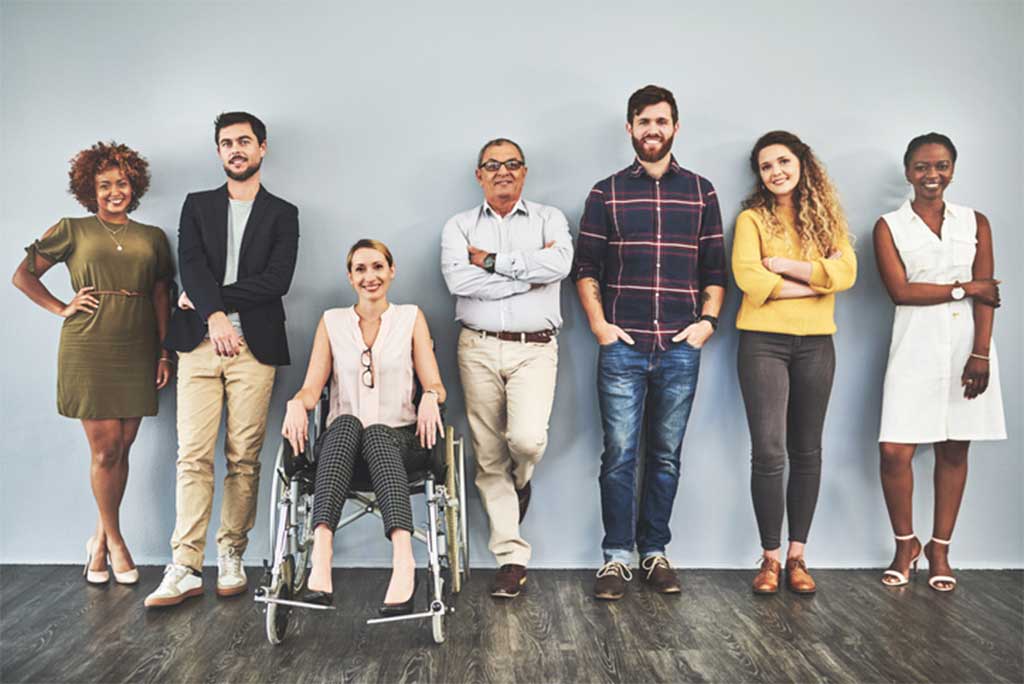 people in a row, standing or in a wheelchair