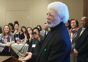 Ron Dellums speaking at podium while audience listens